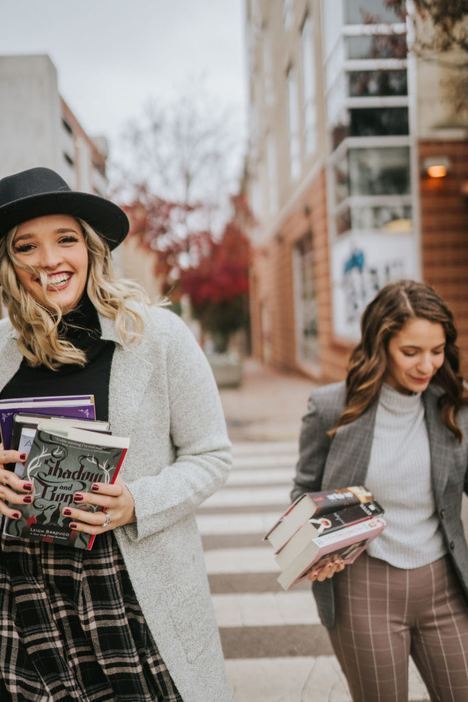 celine and anna walking down knoxville streets carrying books for novelbound podcast